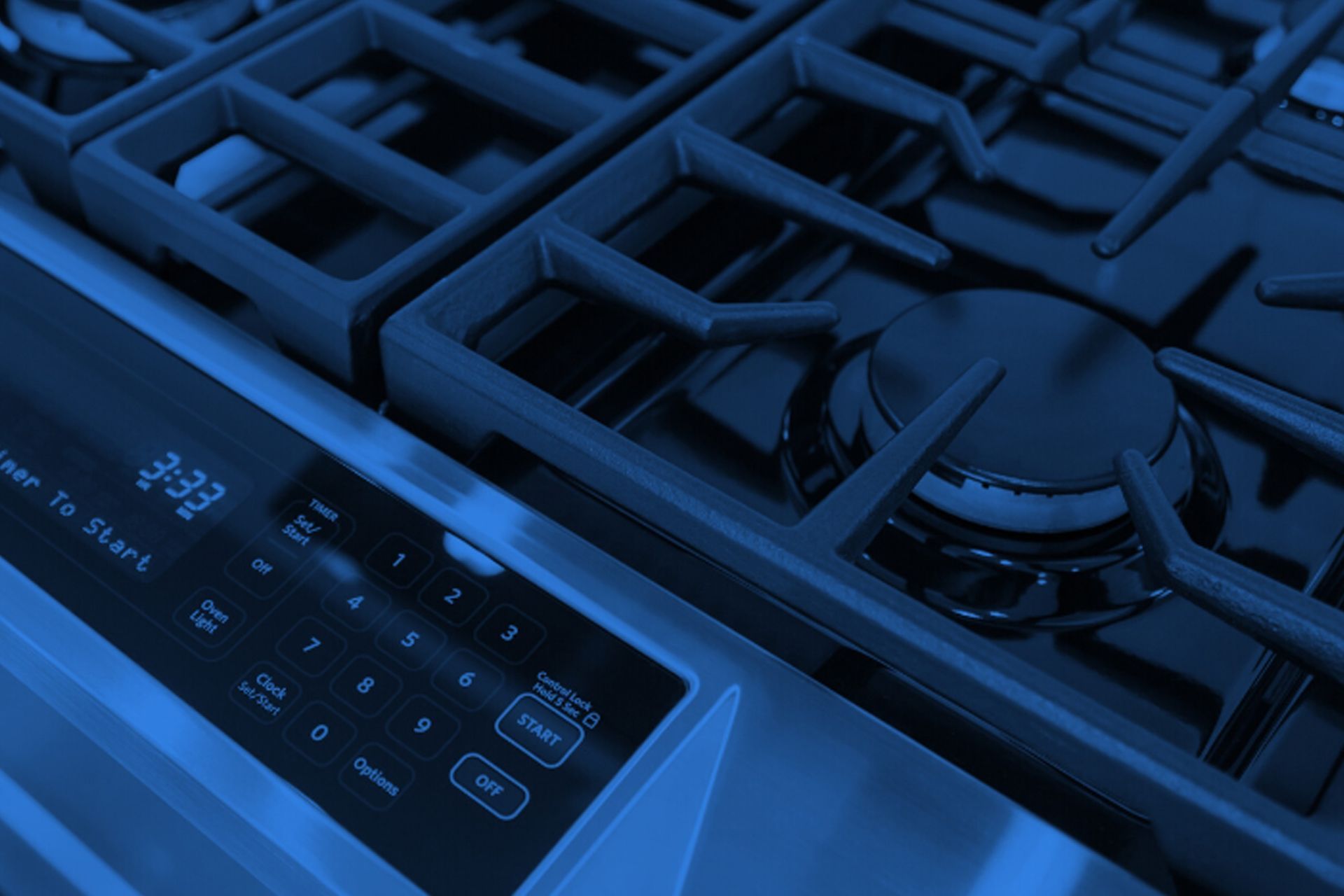 Gas stove top and oven control panel, blue hue.