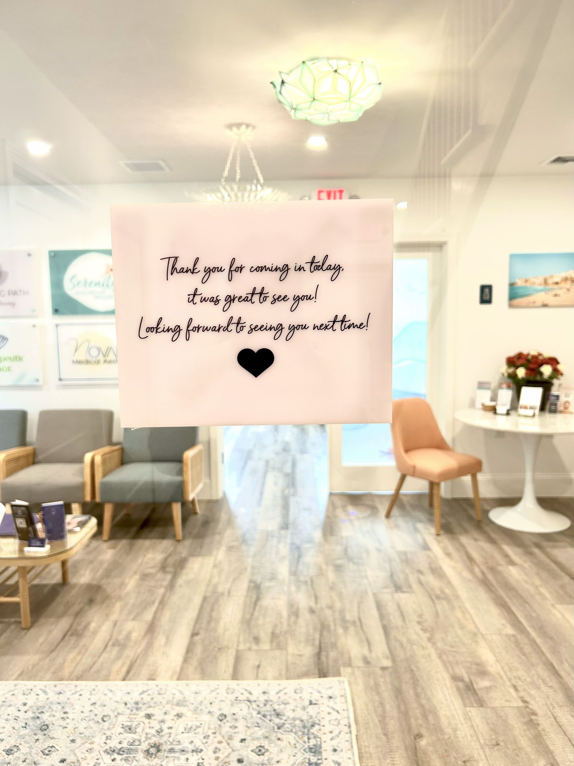 Interior of a waiting room with a sign that says 