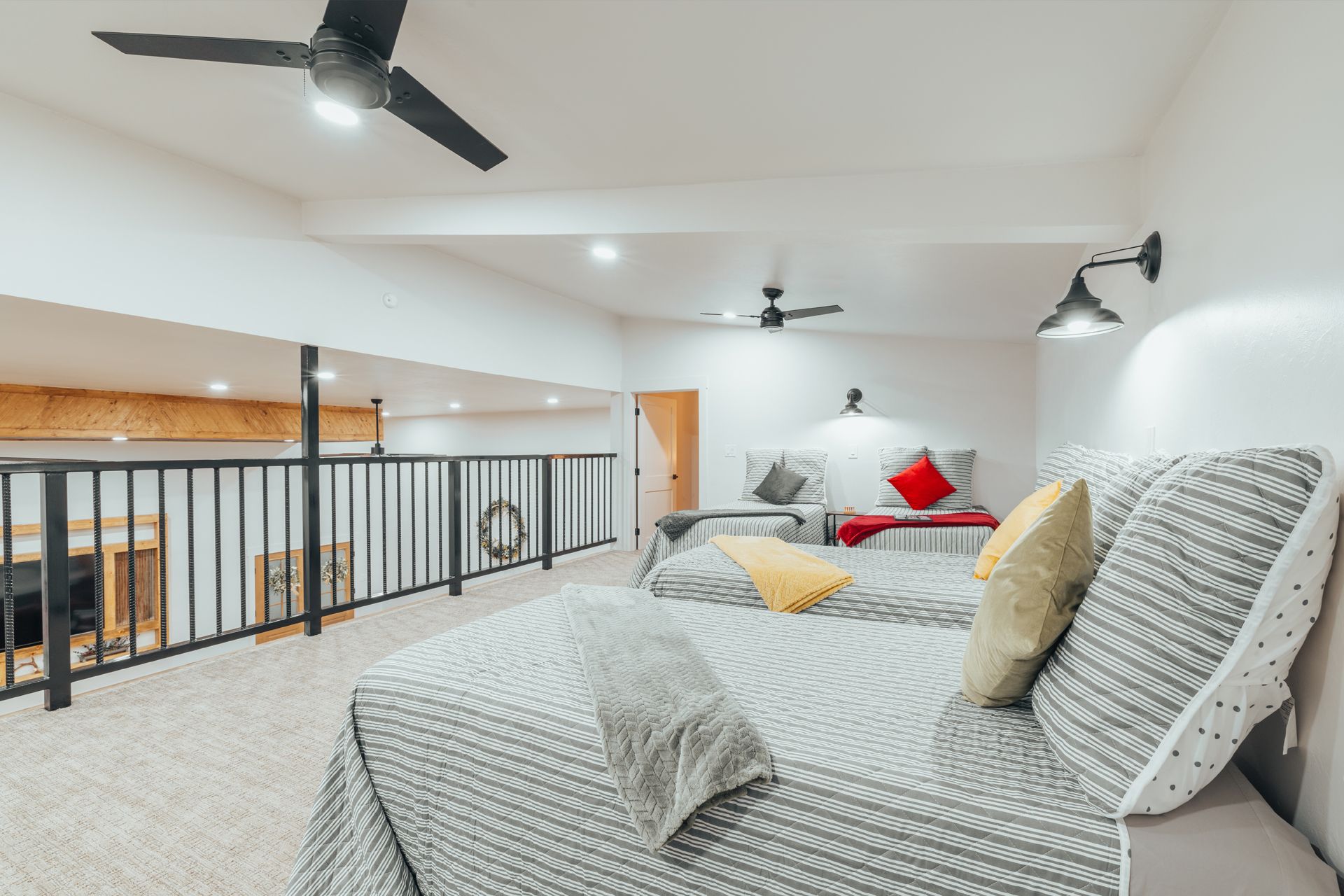 A bedroom with a bed and a ceiling fan.