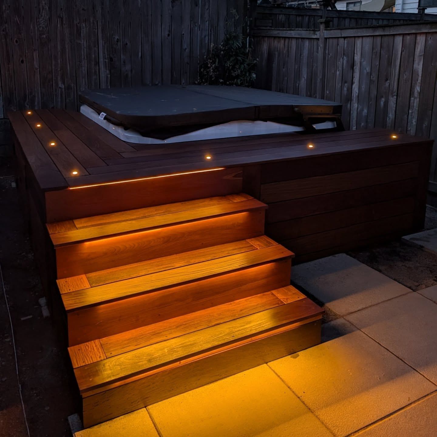 wooden stairs leading up to deck and hot tub