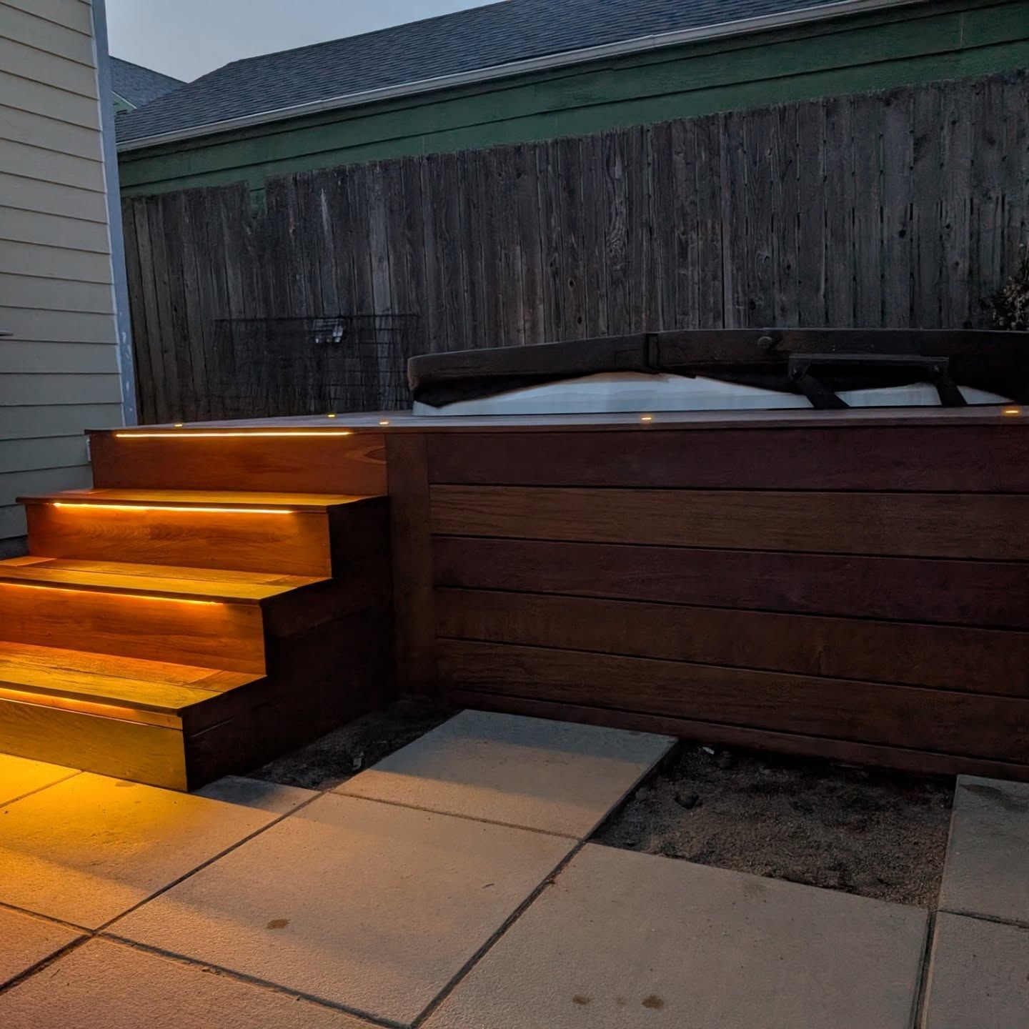wooden stairs leading up to deck and hot tub