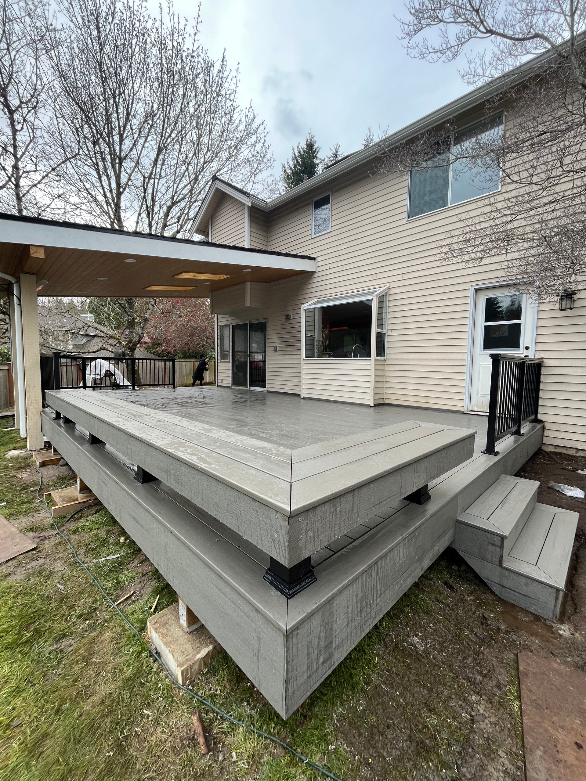 A large deck is sitting in front of a house.