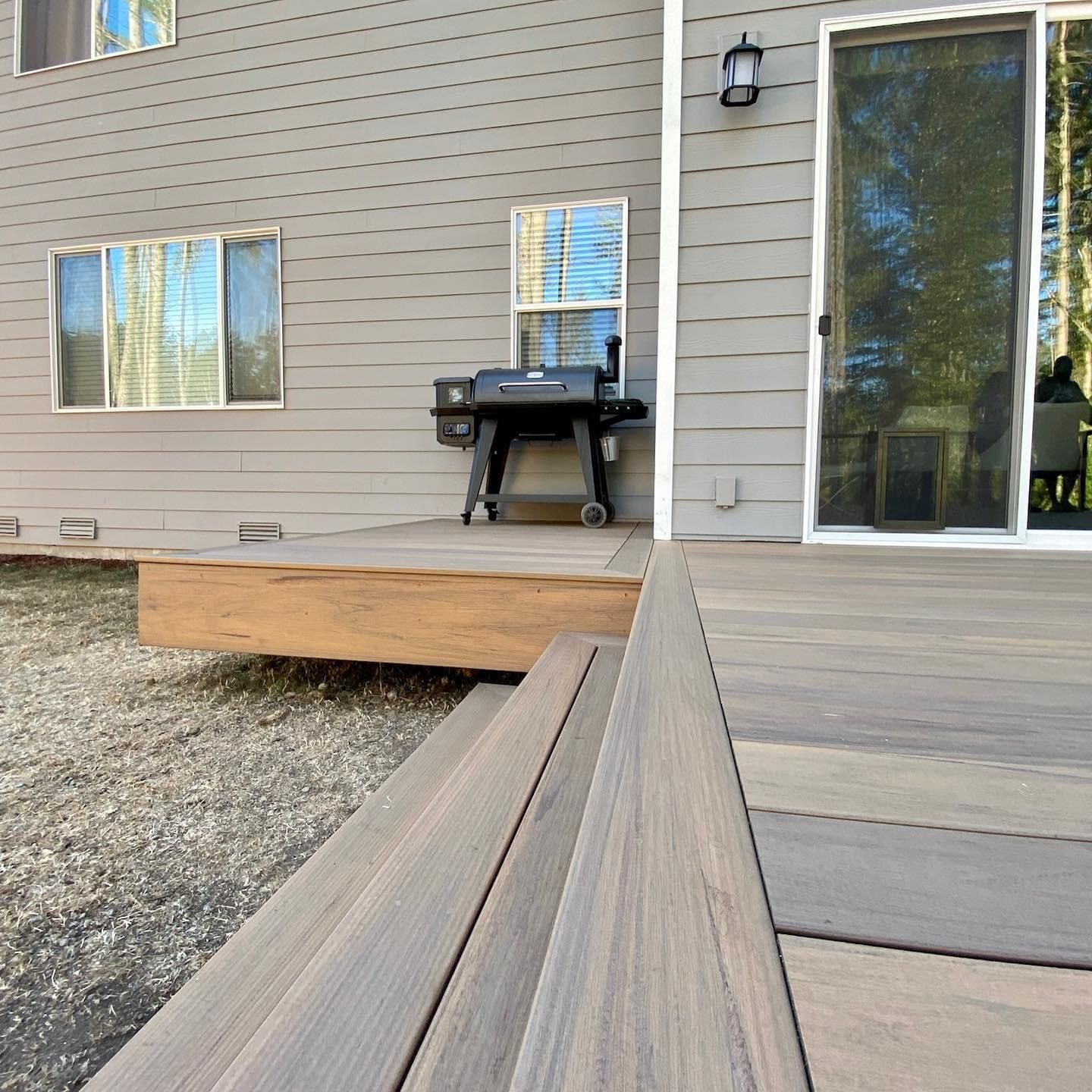 A house with a sliding glass door and a wooden deck