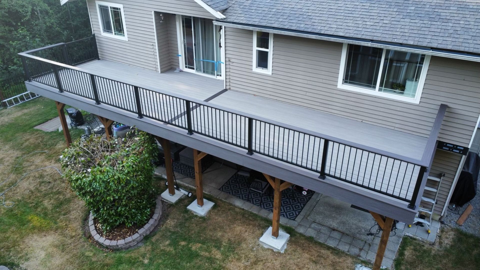 An aerial view of a house with a large deck.