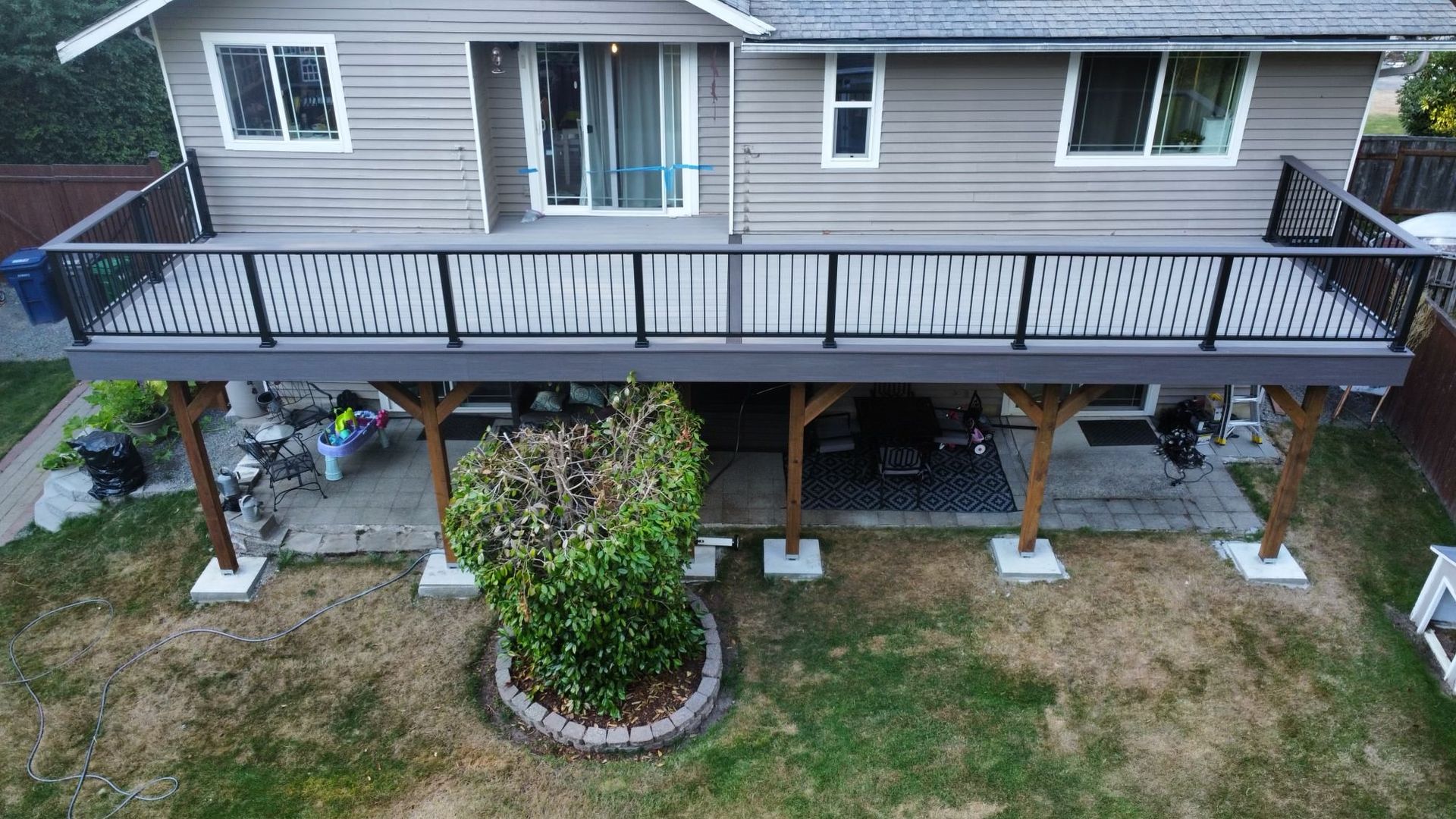 An aerial view of a house with a large deck.