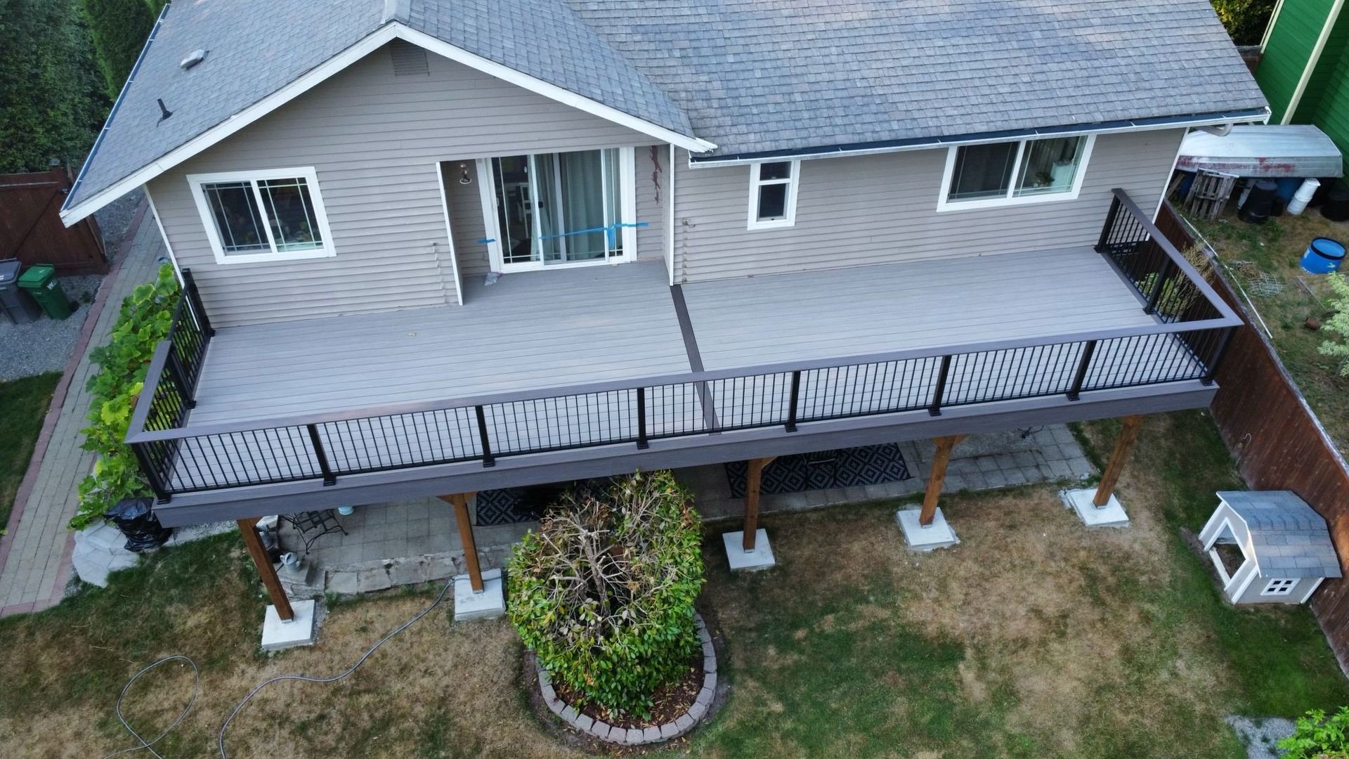 An aerial view of a house with a large deck.