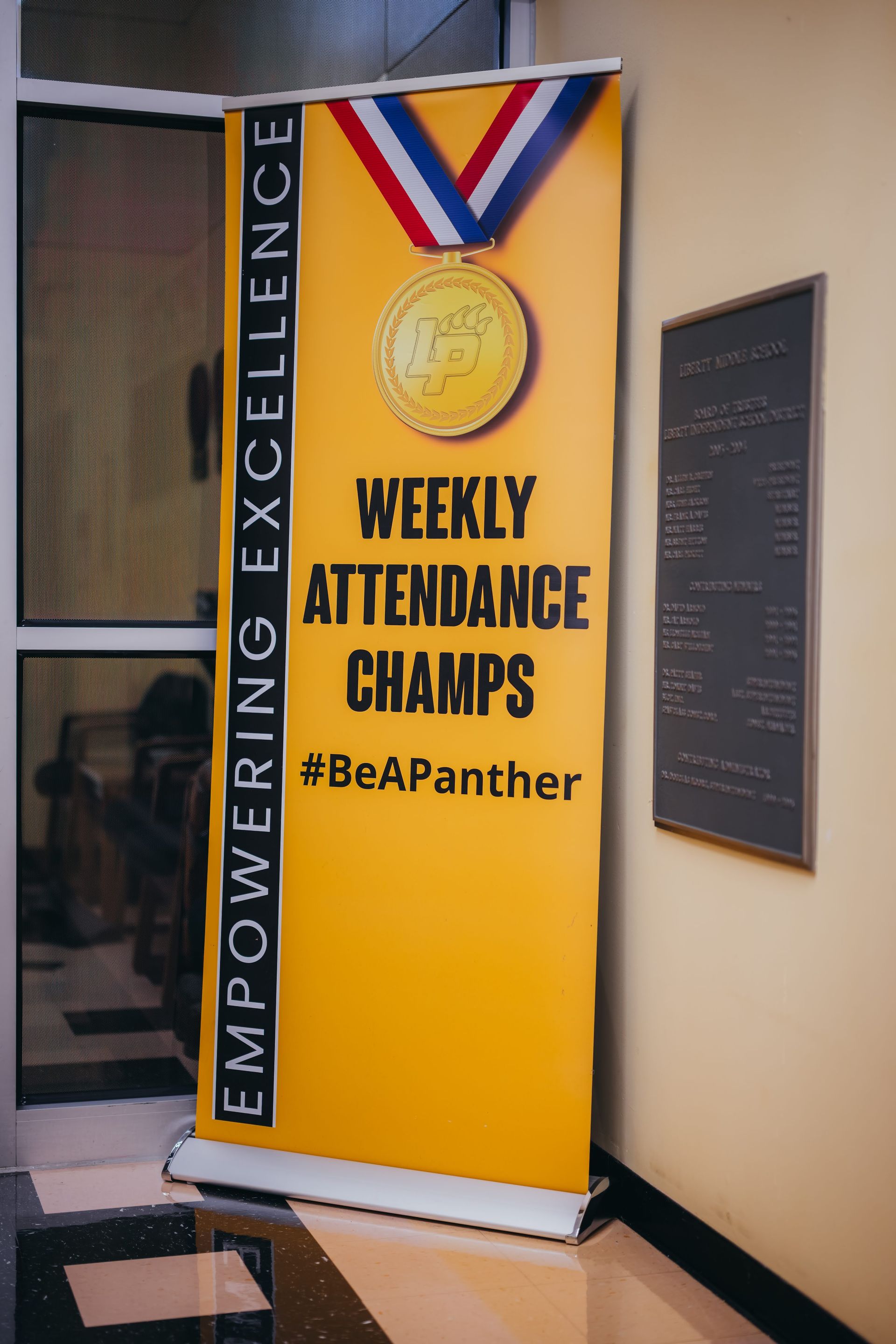 Yellow banner and a bronze plaque.