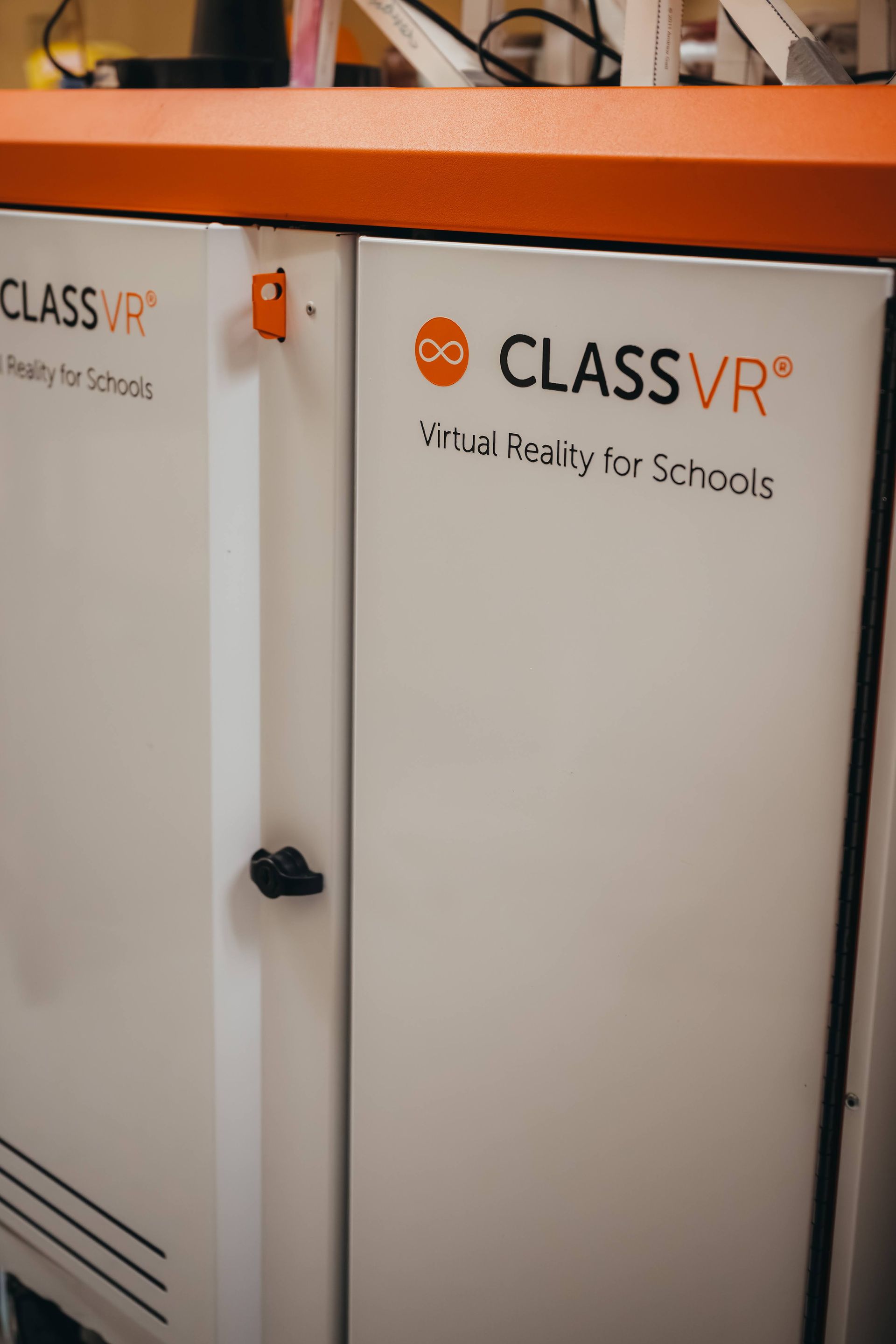 Two white cabinets with orange accents 