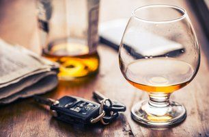 Car keys and glass of brandy