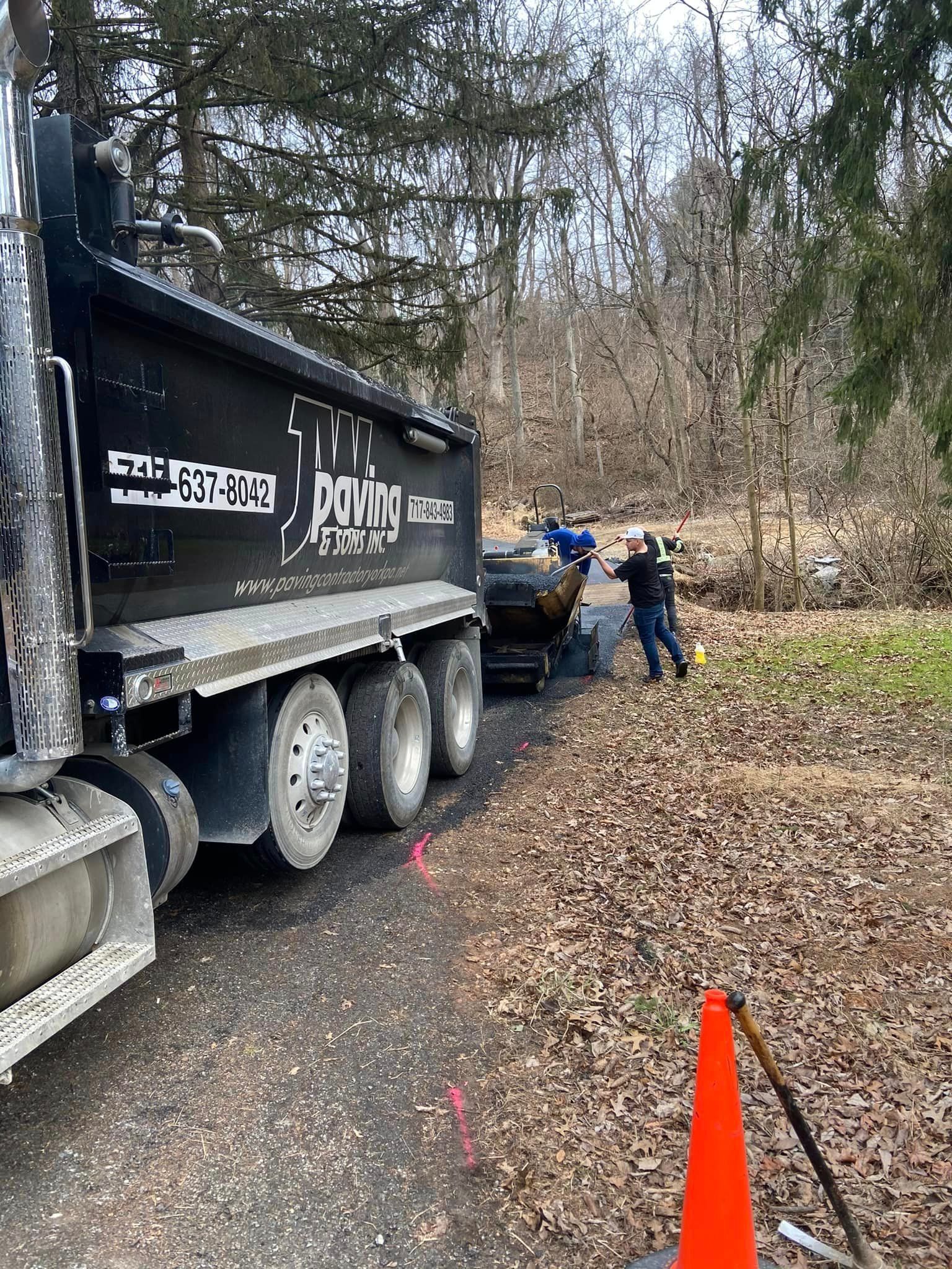 A dump truck is parked on the side of a road.