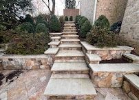 Stone steps leading up a landscaped garden path between brick buildings