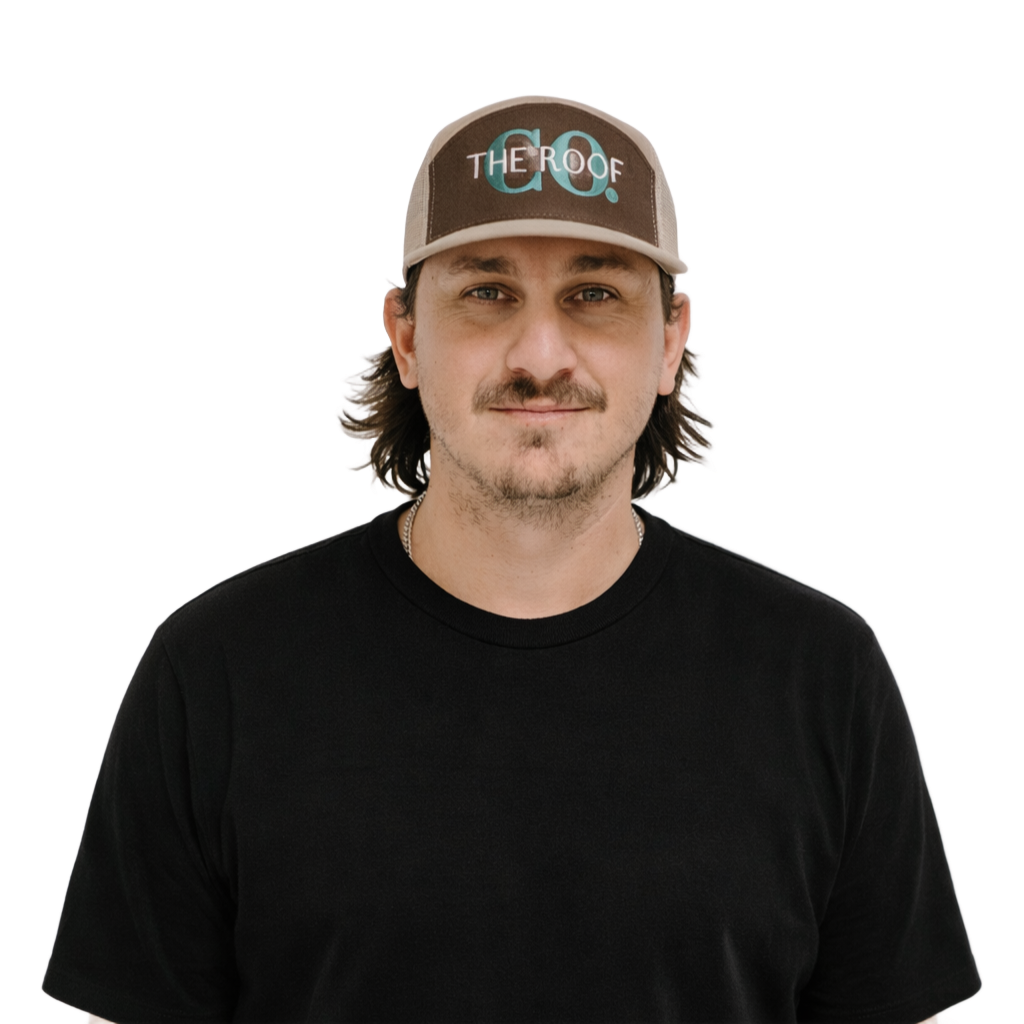 A man wearing a gray baseball cap and black shirt with 