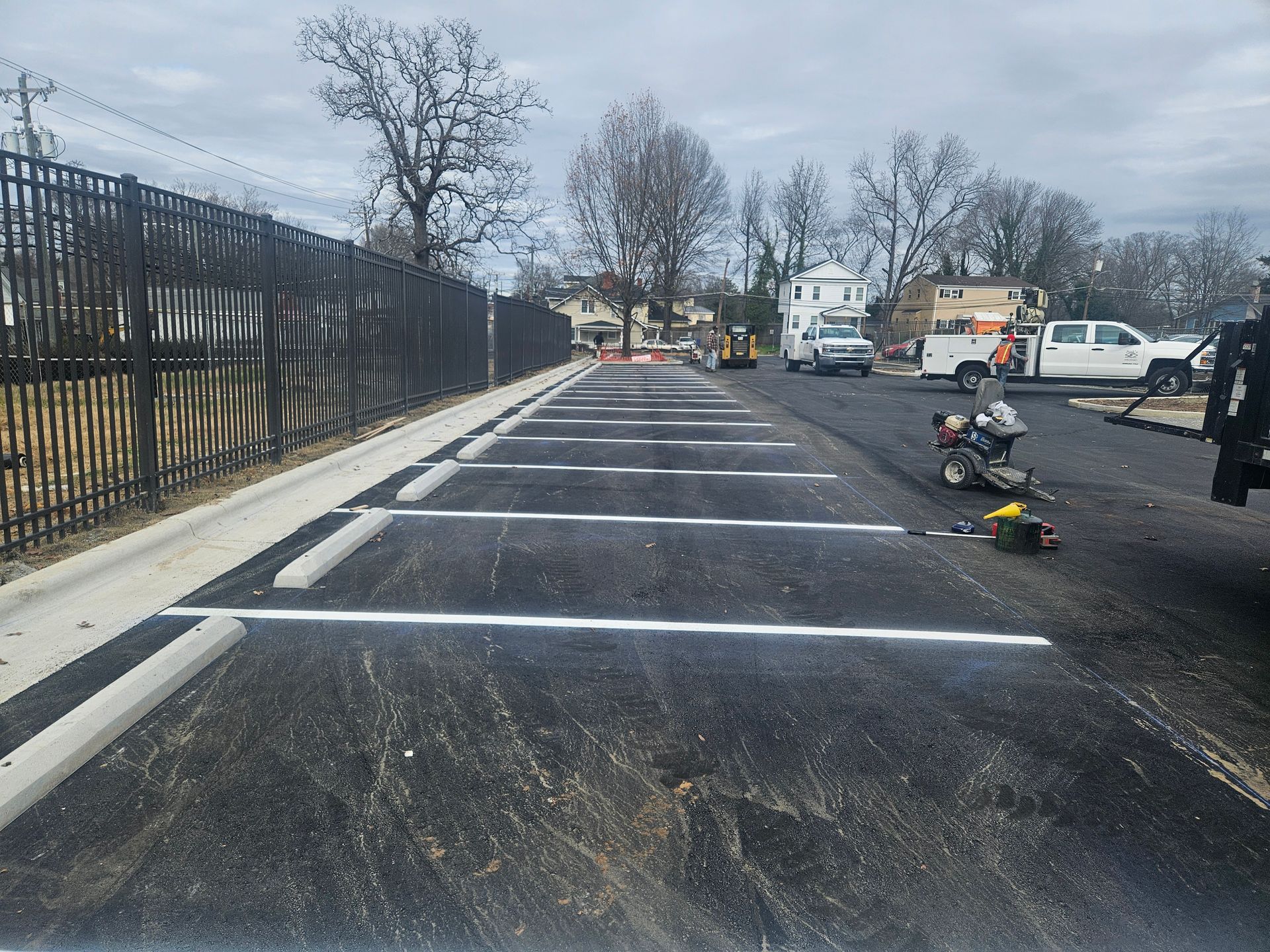 A motorcycle is laying on the ground in a parking lot.
