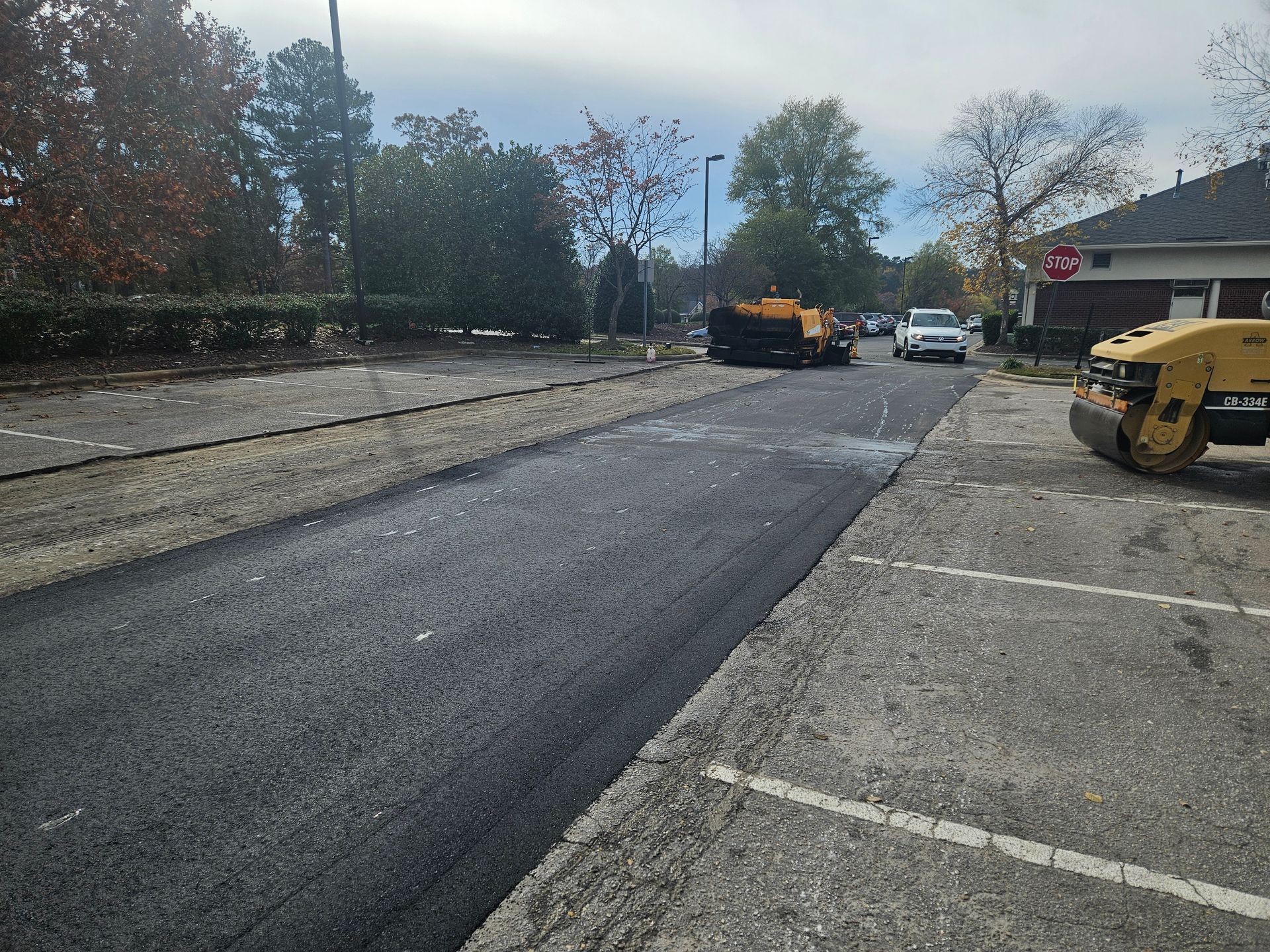 A road is being paved in a parking lot.
