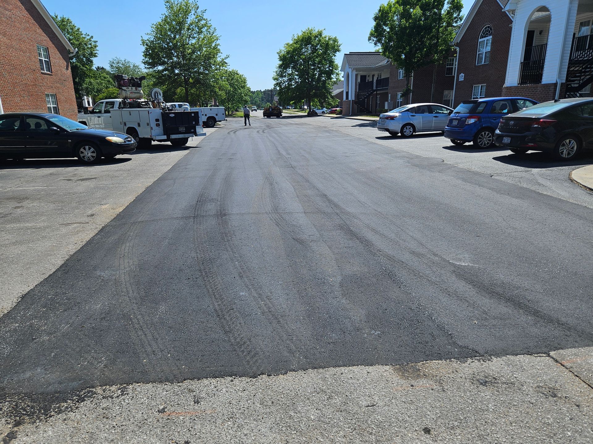 A few cars are parked on the side of the road.