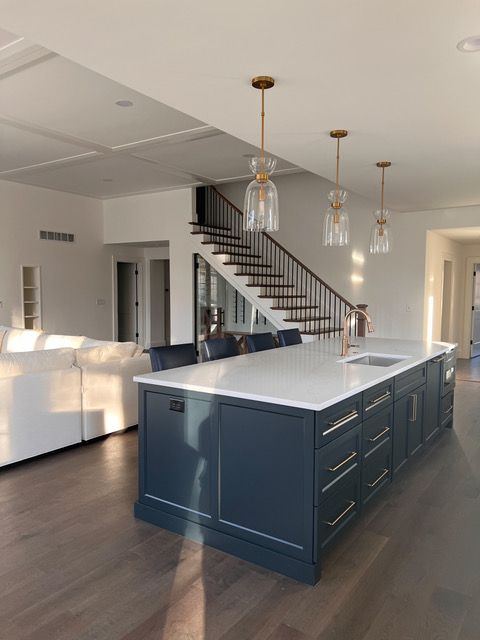 White decorative corbel supporting a kitchen cabinet, with a bronze cabinet handle visible.