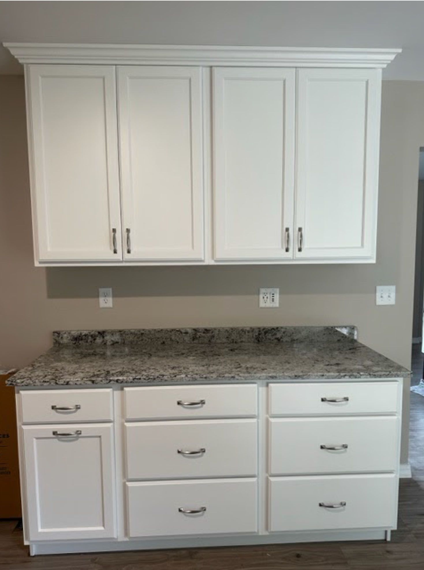 White kitchen cabinets with granite countertop.