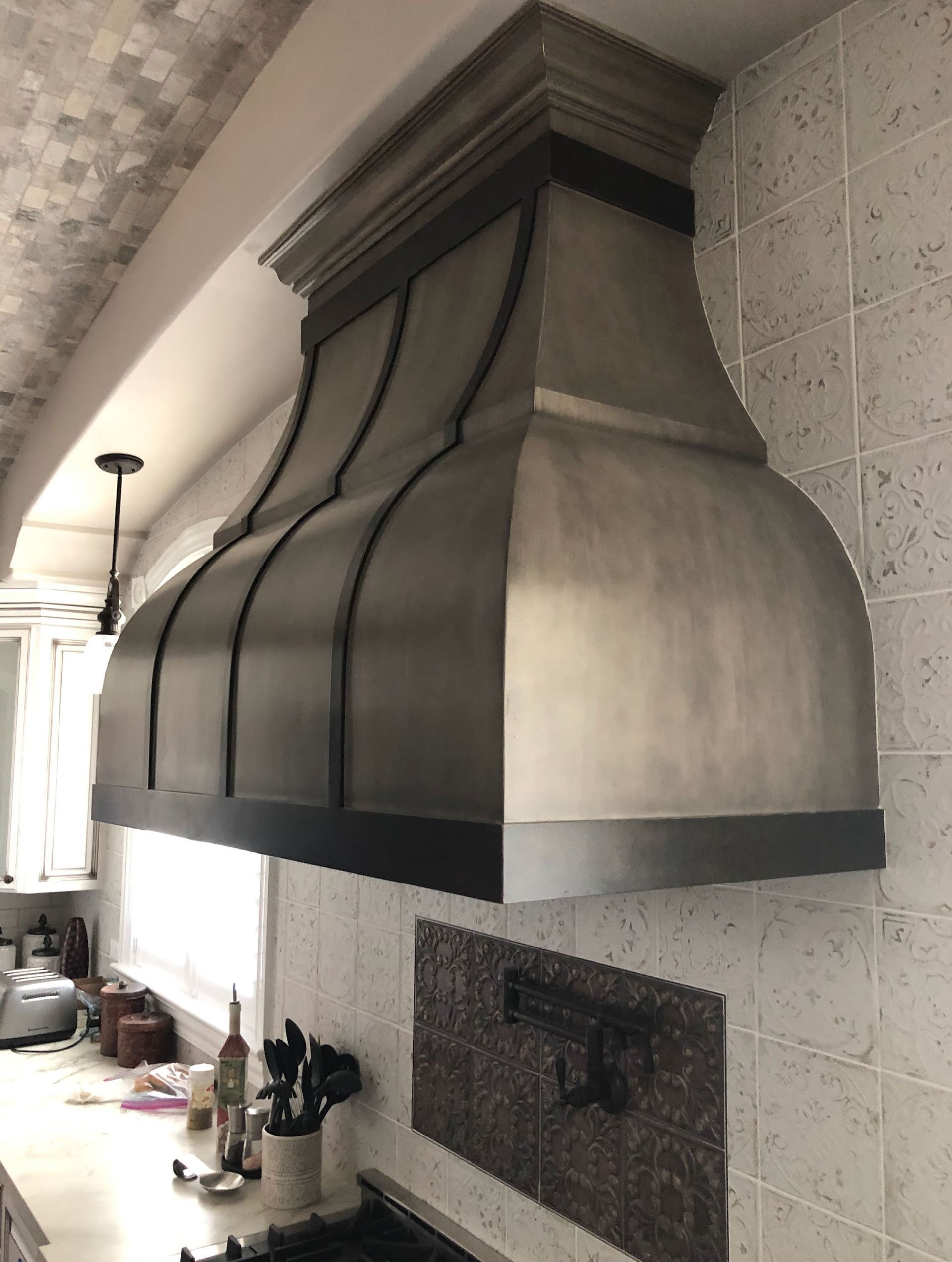 Large gray metal kitchen range hood.