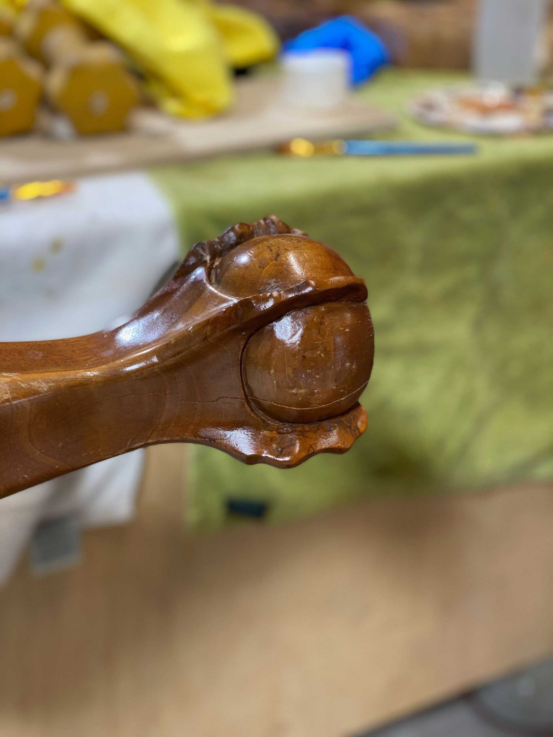 Wooden furniture leg, carved and finished, with a rounded decorative foot.