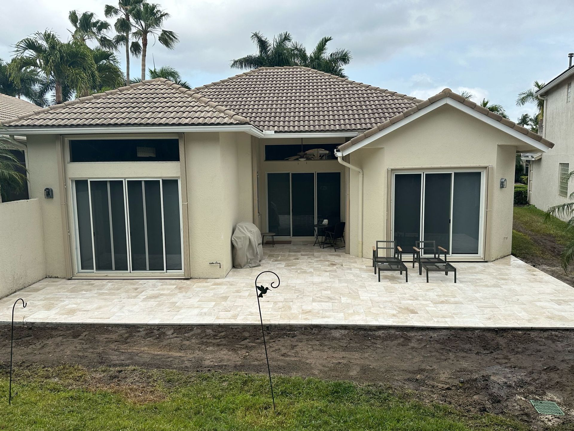 A white house with a patio in front of it