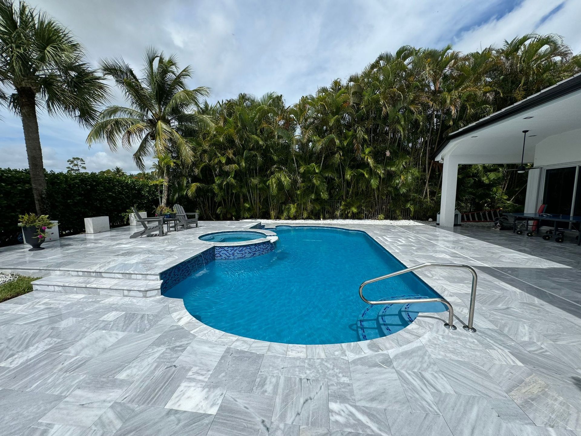 A large swimming pool with palm trees in the background