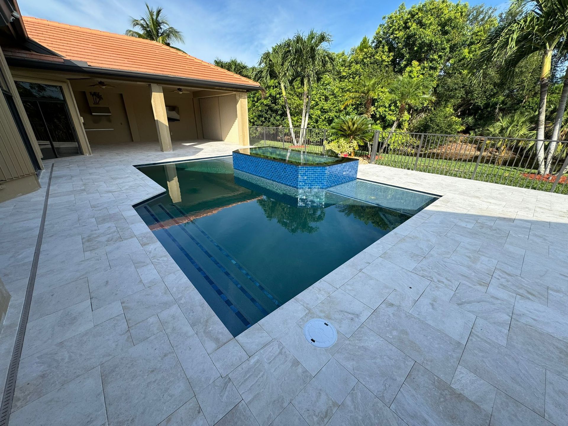 A large swimming pool in the backyard of a house