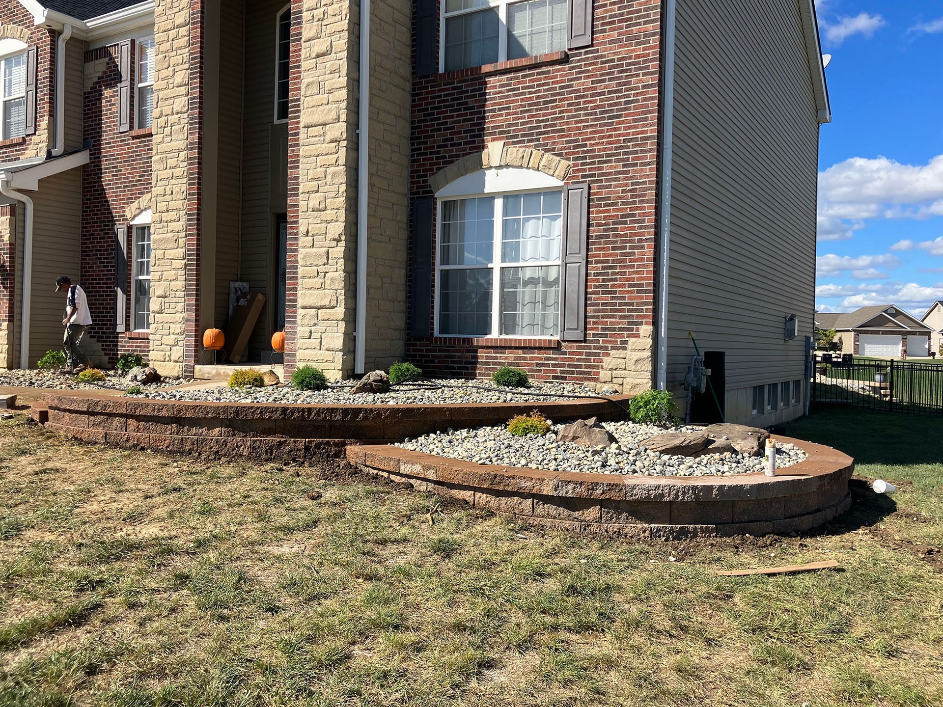 a large brick house with a lush green lawn in front of it