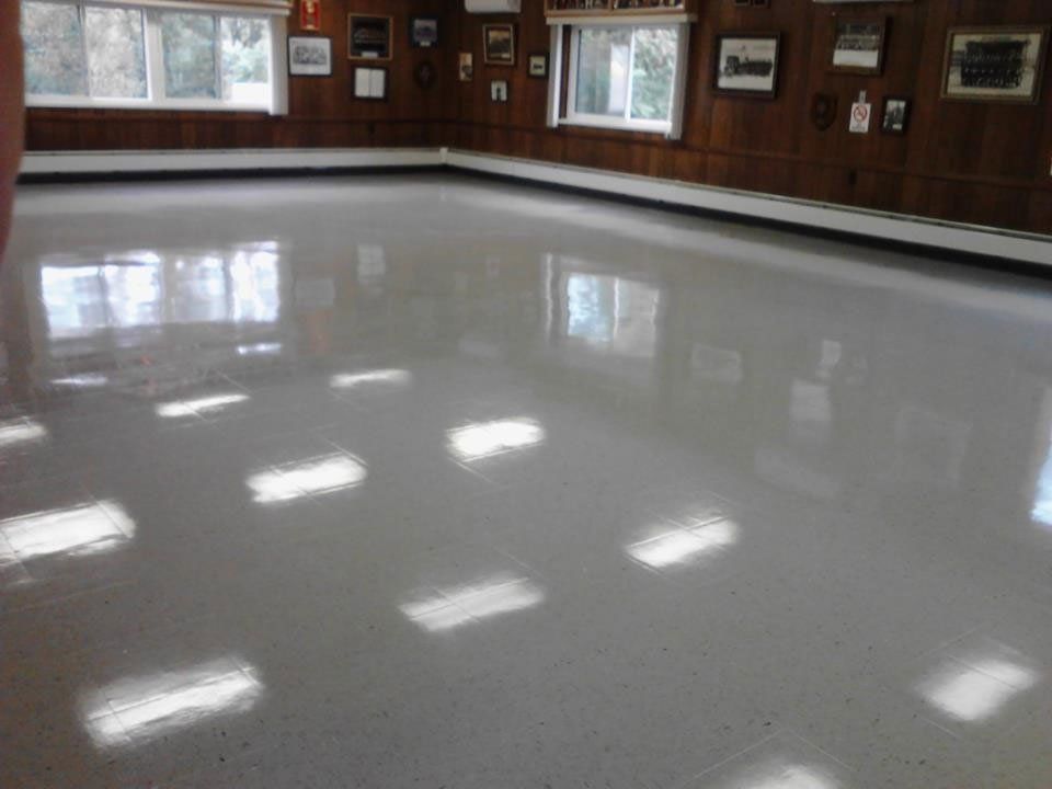 A large room with a white floor and a lot of windows