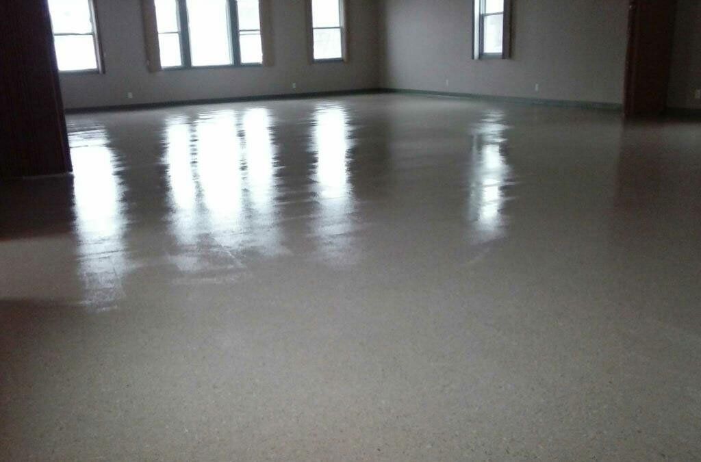 A large room with a shiny floor and windows