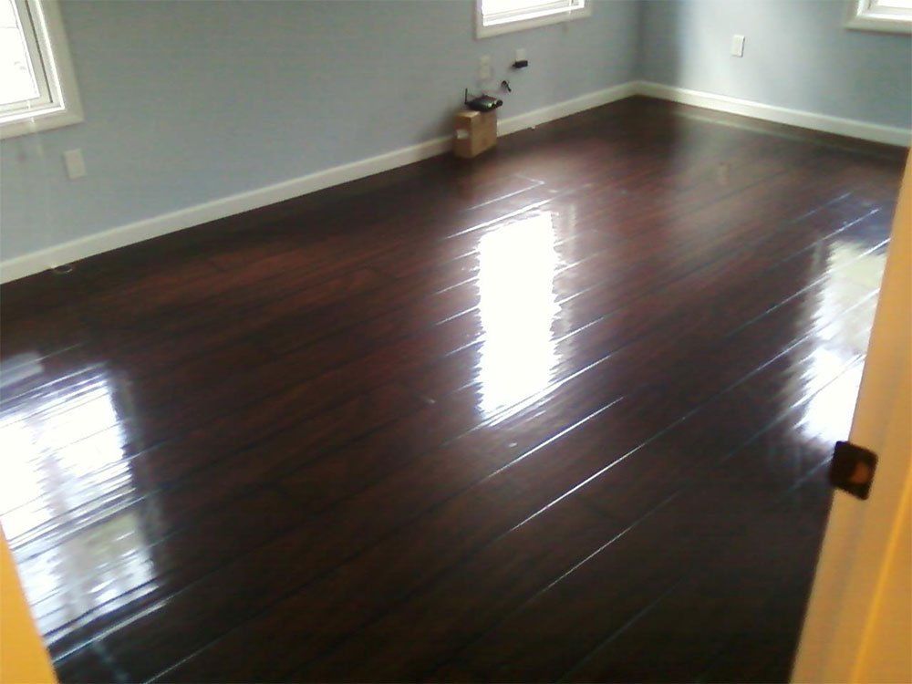 An empty room with hardwood floors and blue walls