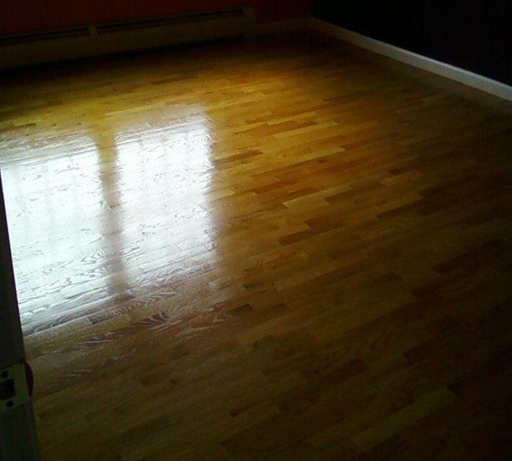 A room with a wooden floor and a window