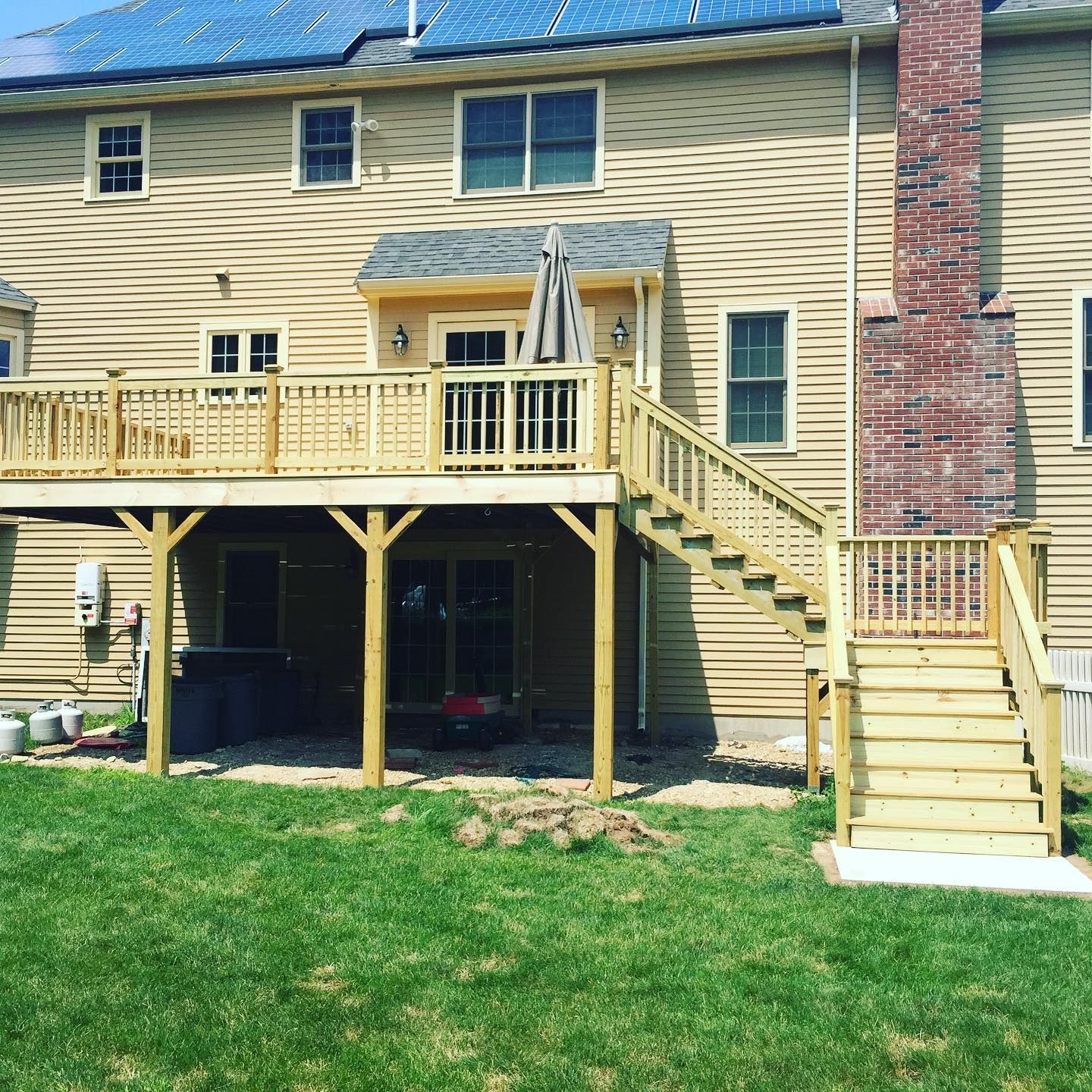 The back of a house with a wooden deck and stairs