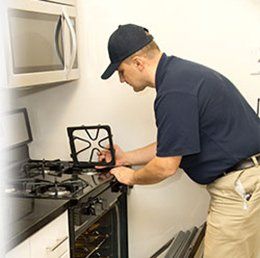 Man repairing stove