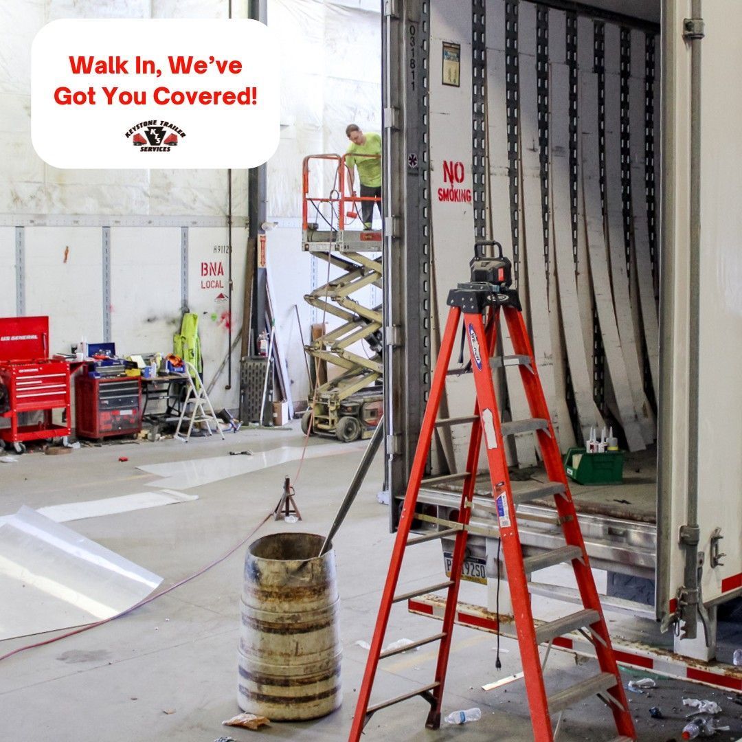 Red scissor lift and step ladder in a warehouse