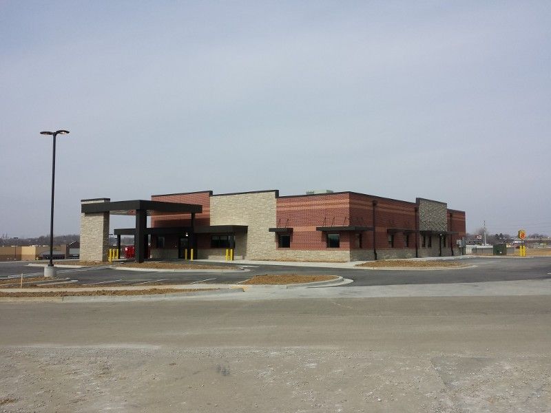 A large building with a parking lot in front of it