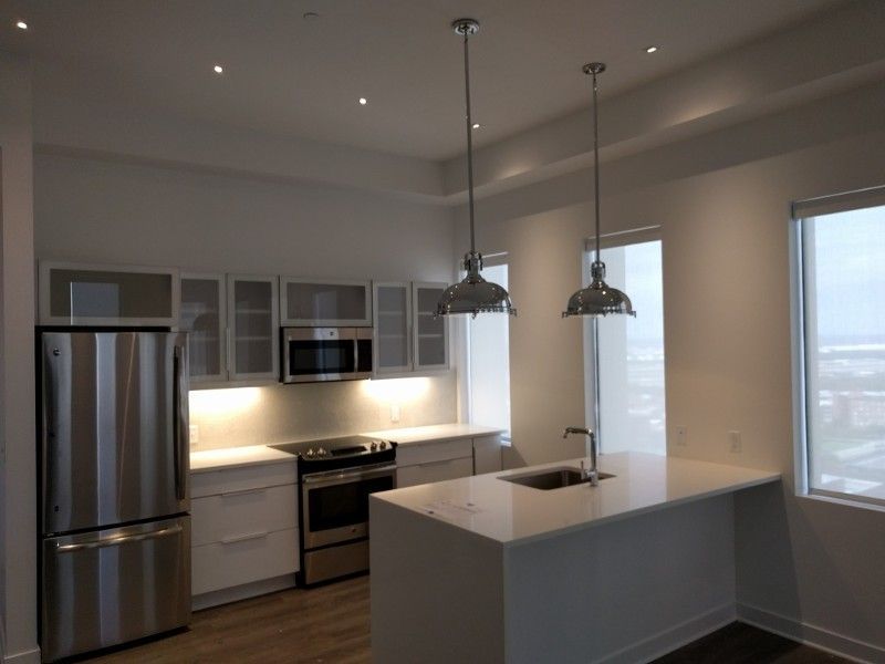 A kitchen with stainless steel appliances and white cabinets