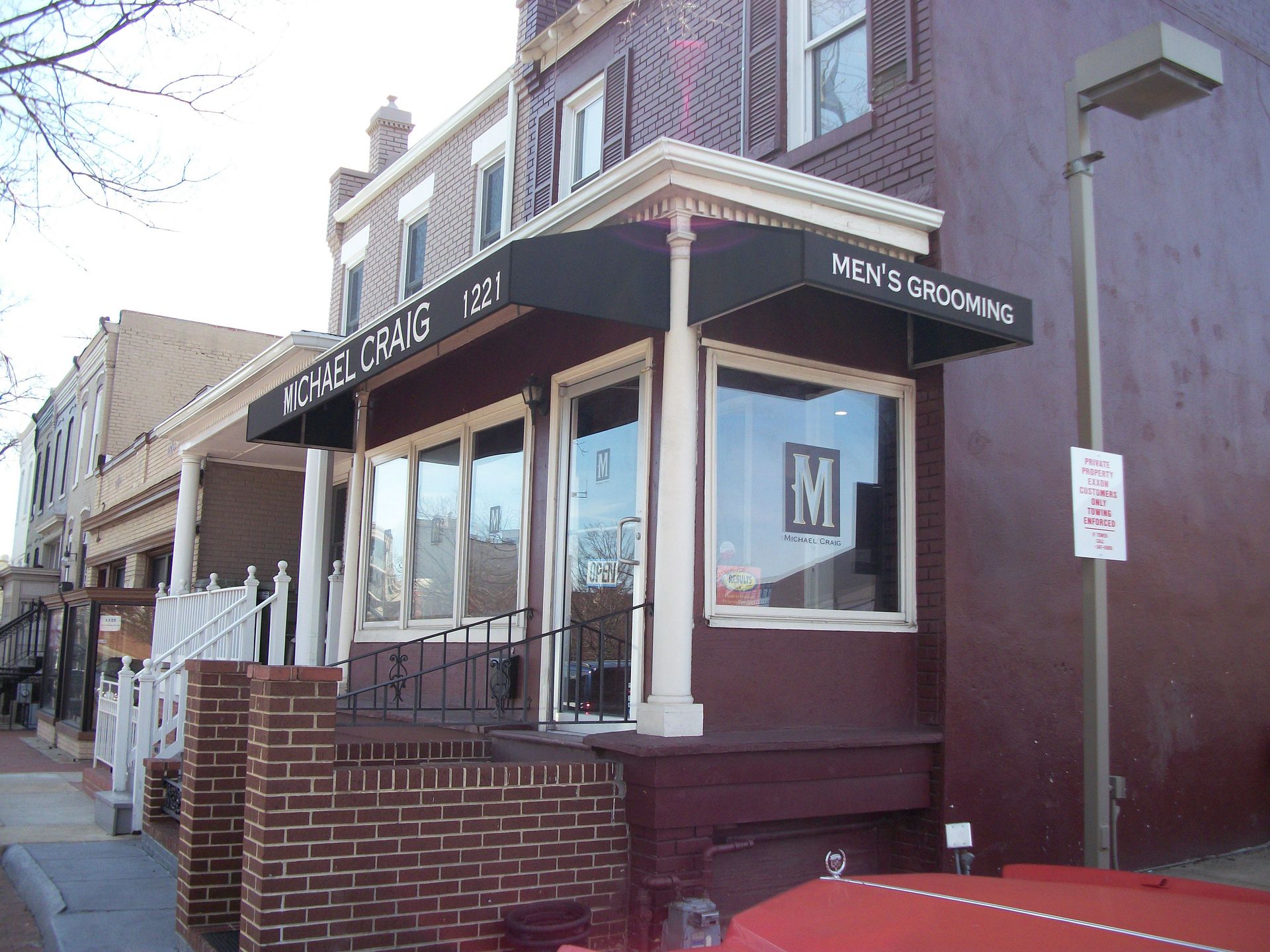 A brick building with a blue awning over the entrance