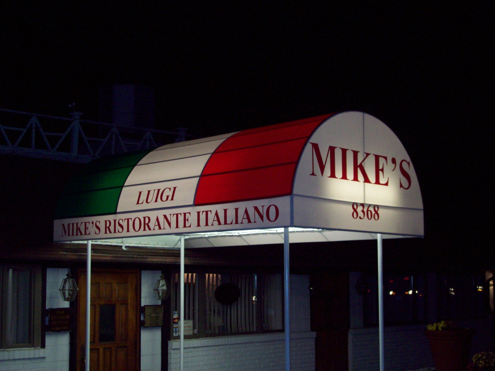 A red white and green awning for mike 's ristorante italiano