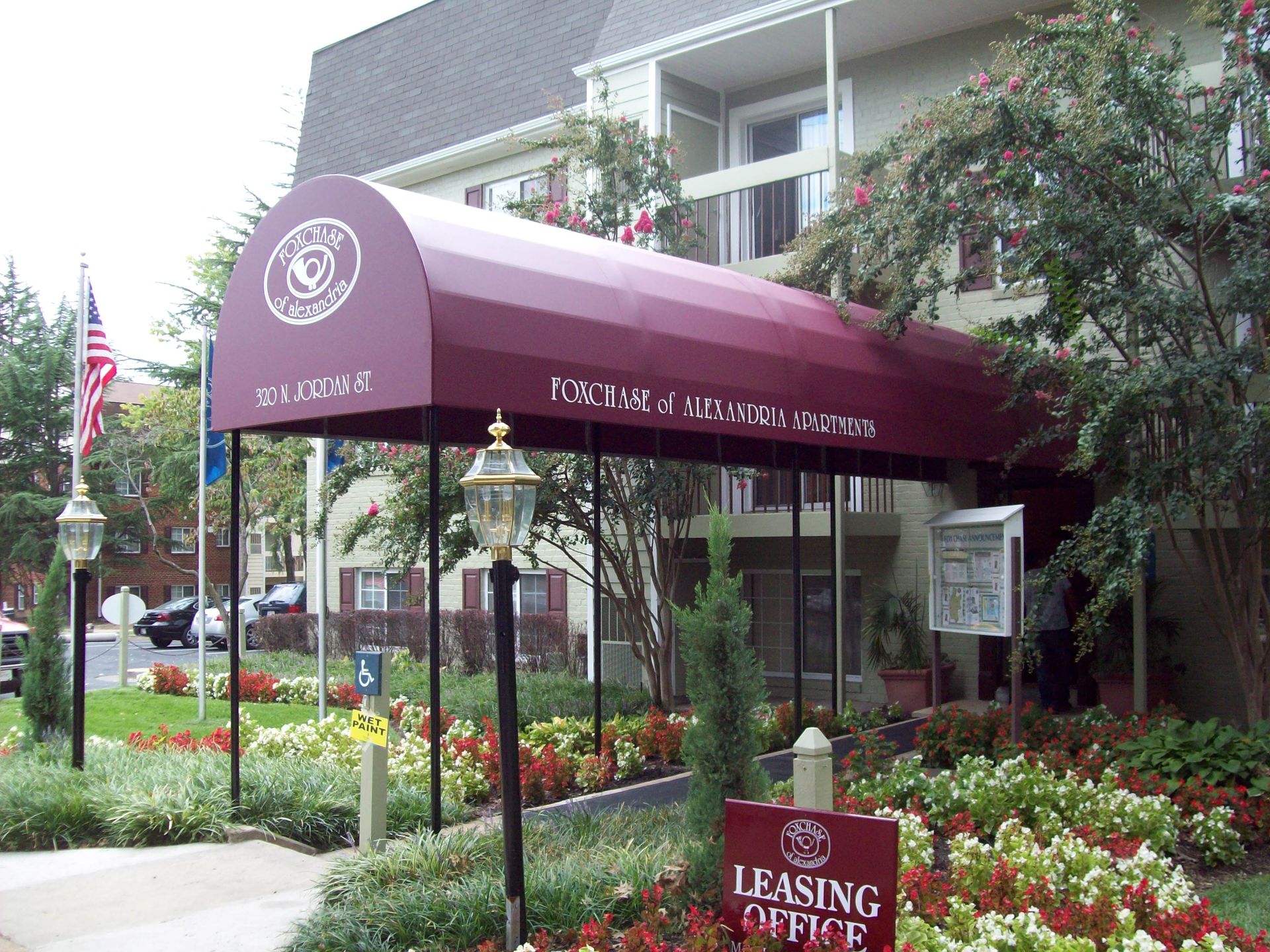 A building with a red awning and a sign that says leasing office