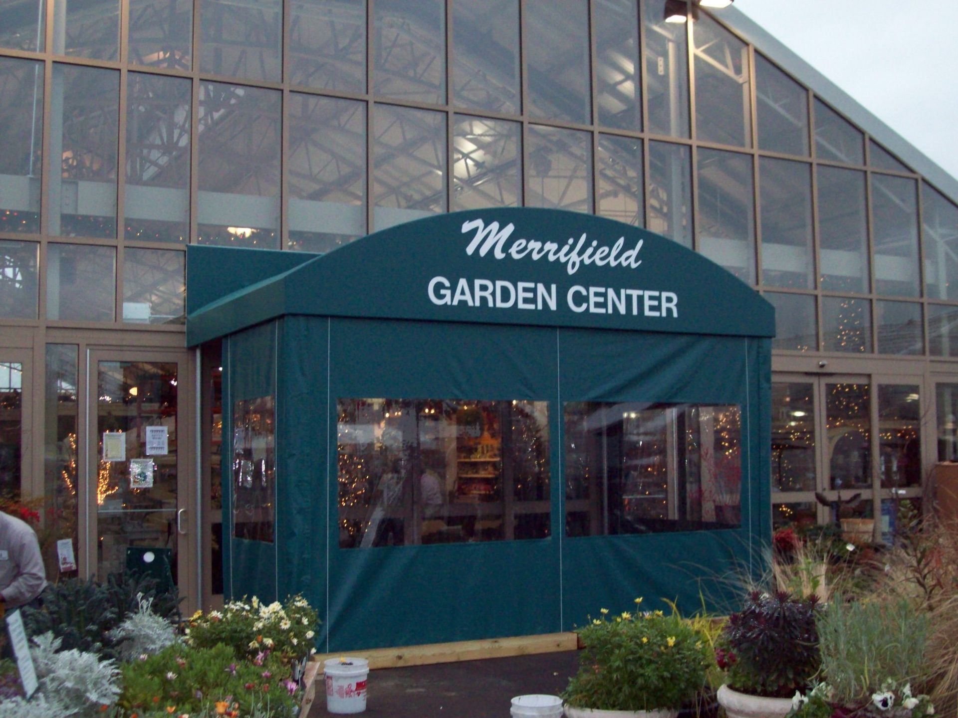 The merrifield garden center has a green awning over the entrance