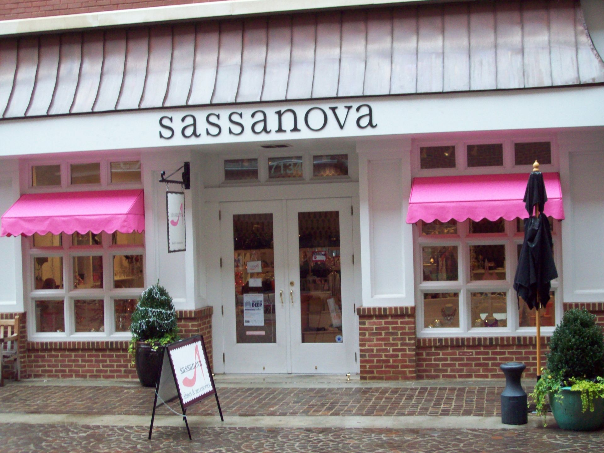 The front of a sassanova store with pink awnings
