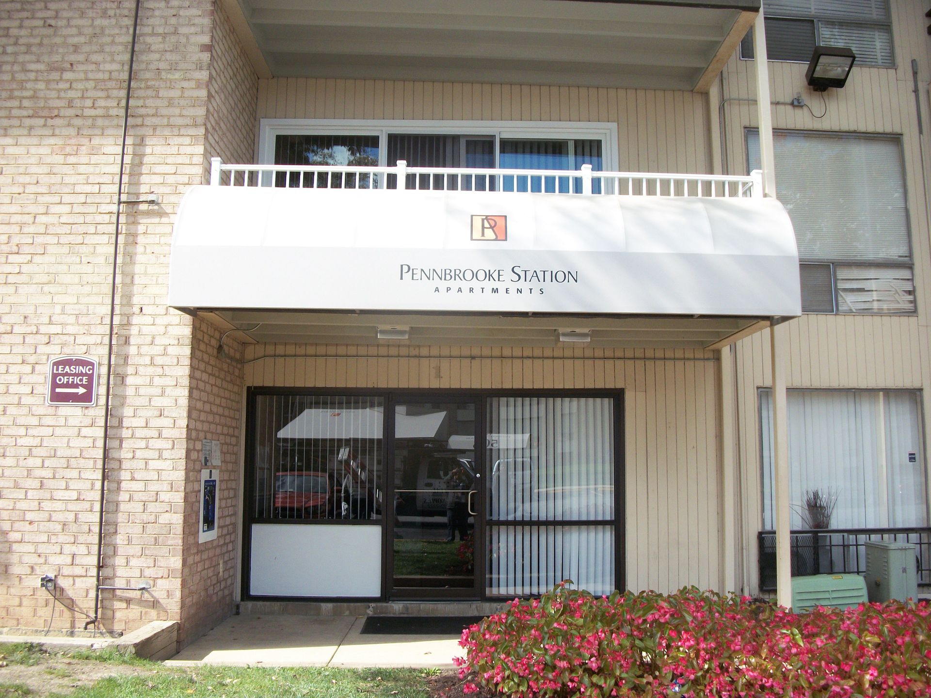 A truck is parked in front of a building that says Long Wave