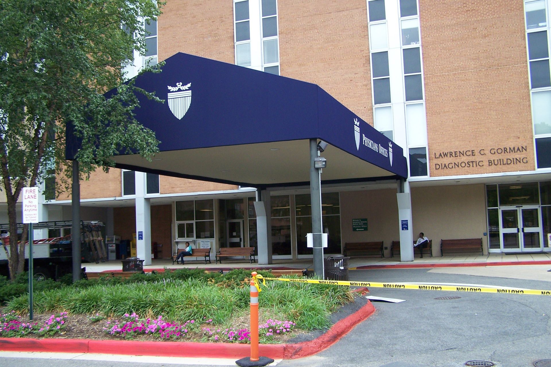 A hospital with a blue awning over the entrance