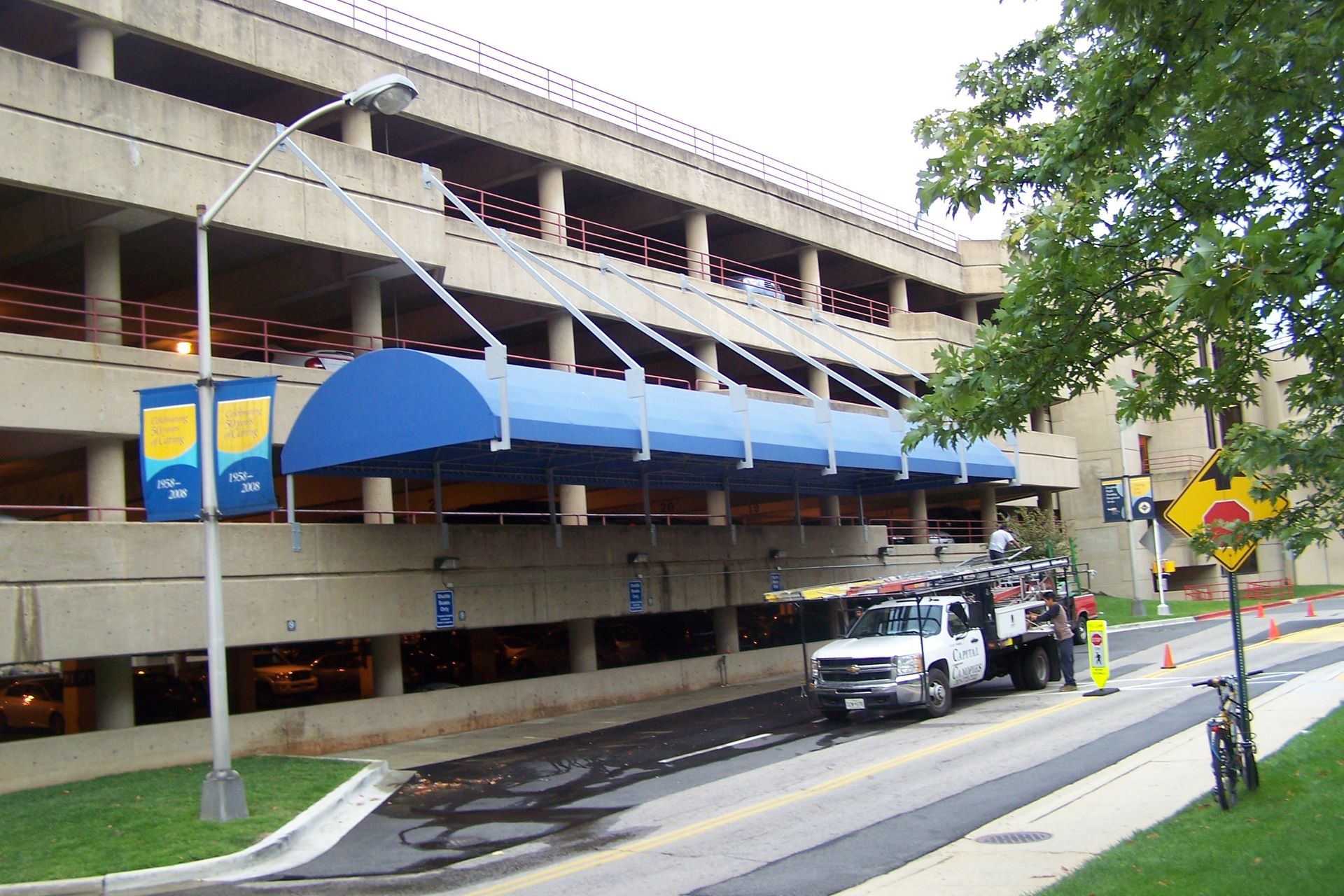 A parking garage with a blue awning over it