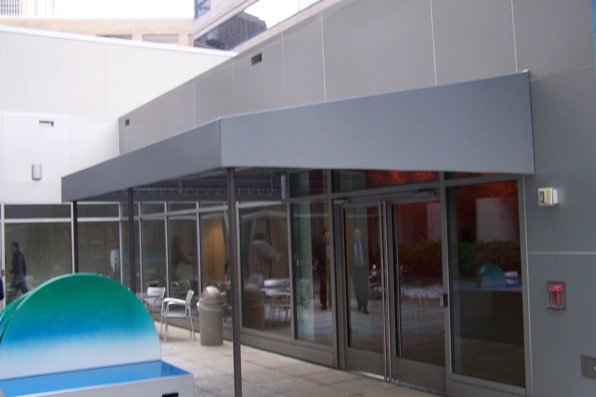 A building with a gray awning over the entrance