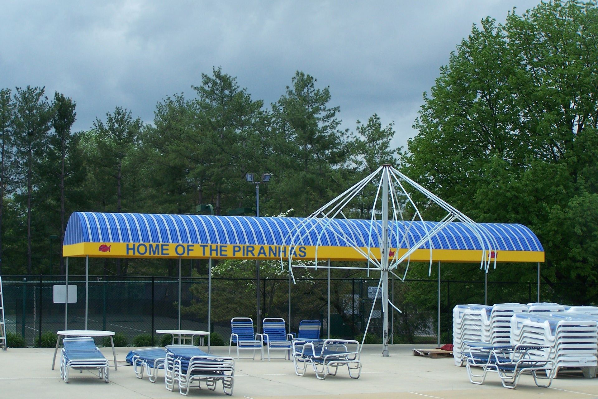A blue and yellow awning says home of the pyramids
