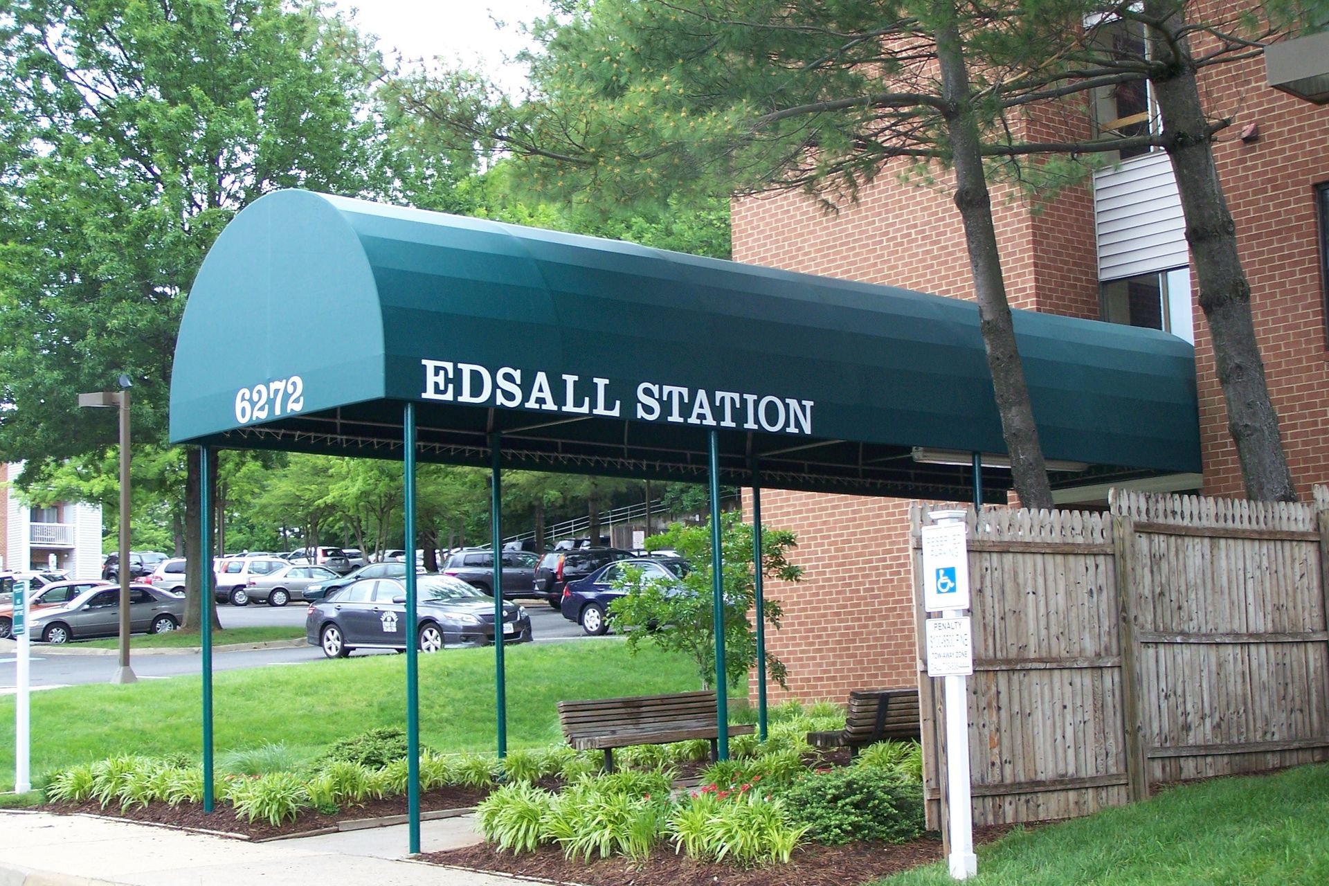 A green awning that says edsal station on it