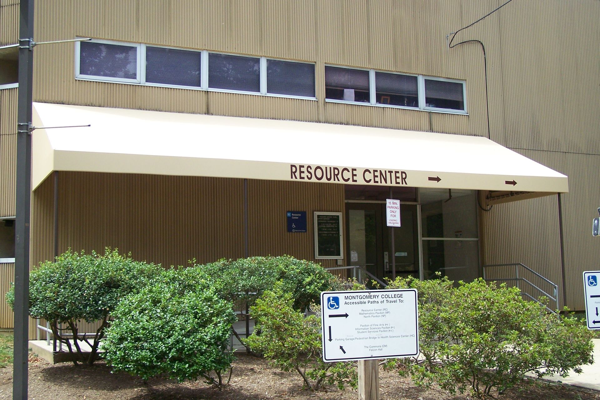 A black and white striped awning on a brick building