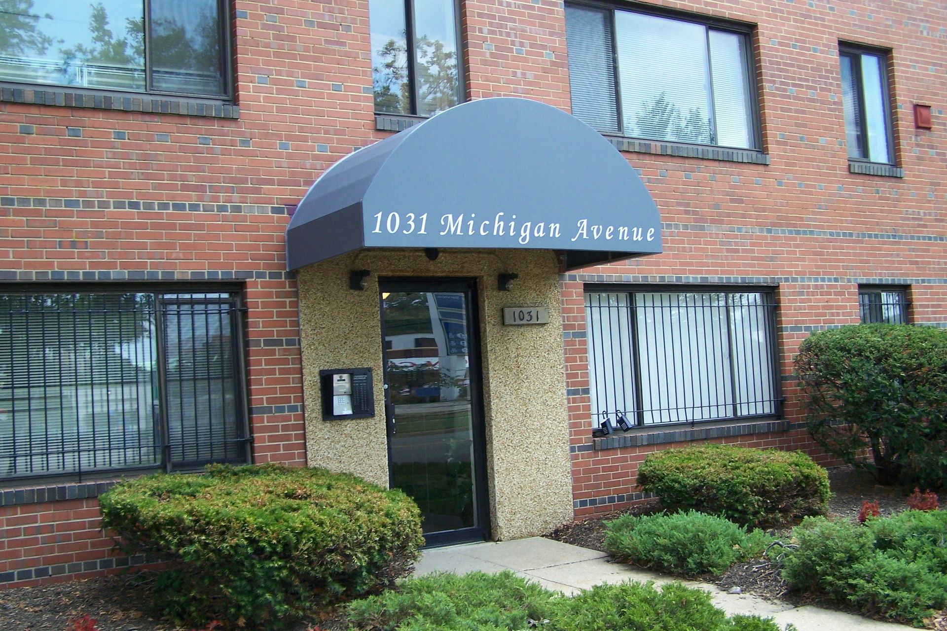 A brick building with a black awning that says 1031 michigan avenue