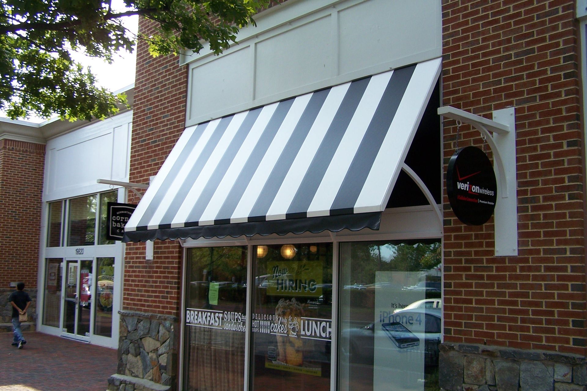 A black and white striped awning on a brick building
